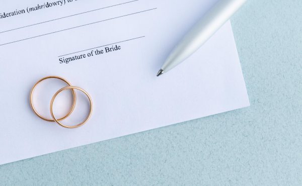 sign-marriage-contract-form-agreement-with-pair-wedding-rings